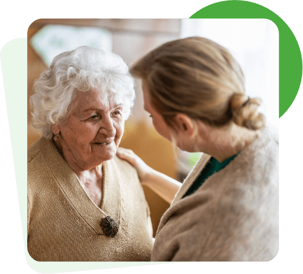 elderly woman being comforted by a carer